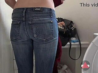 Skinny girl peels off her jeans in the bathroom